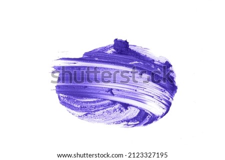 Close-up of the creamy texture of makeup.The very peri color of the cosmetic product. Smudged lipstick stains stand out against a white isolated background. High quality photo