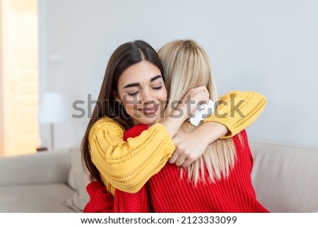 Candid diverse girls best friends embracing standing indoors, close up satisfied women face enjoy tender moment missed glad to see each other after long separation, friendship warm relations concept Royalty-Free Stock Photo #2123333099