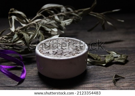 Bowl with ashes, olive branch and cross, symbols of Ash Wednesday Royalty-Free Stock Photo #2123354483