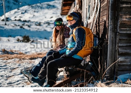 Mountaineer backcountry ski walking ski woman alpinist in the mountains. Ski touring in alpine landscape with snowy trees. Adventure winter sport. Freeride skiing