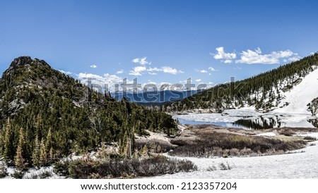 St. Mary's Glacier with its lake, forests and snowy hills. 