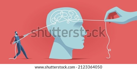Man trying to untangle a knot of thoughts in the human brain Royalty-Free Stock Photo #2123364050