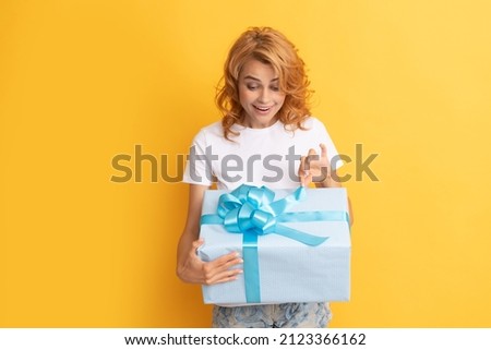 curious happy redhead woman open gift box. anniversary