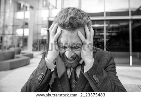 stressed frustrated bearded businessman in formal suit, rage Royalty-Free Stock Photo #2123375483