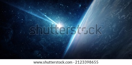 Comet, asteroid, meteorite flying to the planet Earth. The concept on the theme of the apocalypse, armageddon, doomsday, Judgment Day. Elements of this image furnished by NASA.  Royalty-Free Stock Photo #2123398655