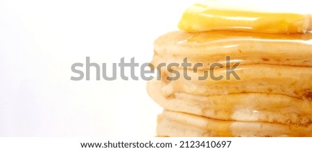 Pancake Day Fat Tuesday Lent stack of pancakes closeup, with drizzling honey syrup. Sized to fit popular social media and web banner.