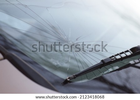 breakage of the windshield of a car, vehicle glass damage Royalty-Free Stock Photo #2123418068