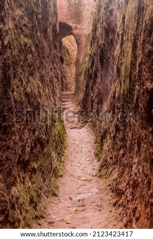 Narrow passage connecting rock-hewn churches in Lalibela, Ethiopia Royalty-Free Stock Photo #2123423417