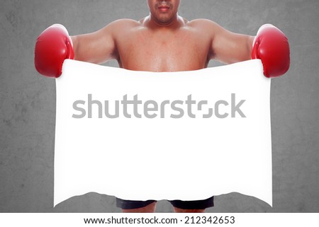 fight and competition sign with an red boxing glove holding a blank white banner as a business symbol of competitive sale or boxing specials against concrete wall 