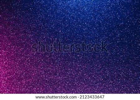 Neon glitter background. Grain texture. Defocused sparkles. Bokeh glow. Fluorescent blue magenta pink color gradient light shimmering sequin pattern. Royalty-Free Stock Photo #2123433647