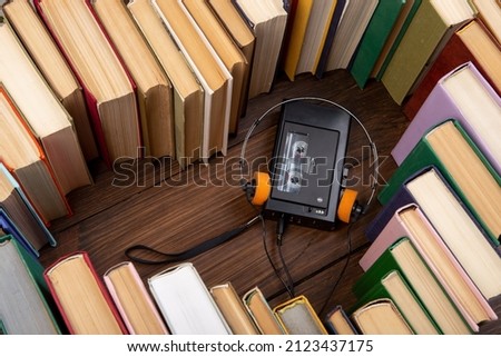 Listening Audio book concept heart shape of book, headphones and vintage cassette tape player. Love to reading