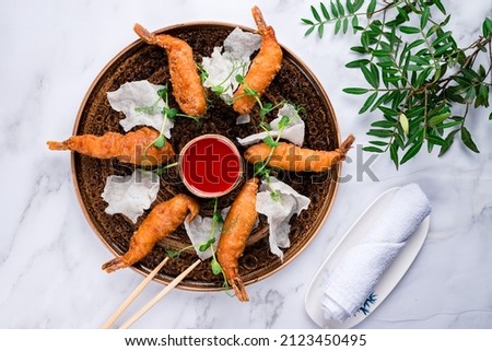 King Prawn Tempura, Crispy king shrimps in tempura served. Japanese dish battered deep fried seafood Tiger Prawns with sauce