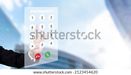 Dialing on virtual telephone keypad with transparent telephone buttons, businessman touch Emergency button of telephone number on screen, Finger touch number on smartphone to make a call, close up, Royalty-Free Stock Photo #2123454620