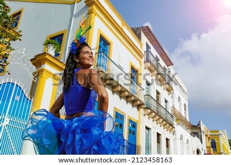 Beautiful Latin dancer dressed up for Carnival on the streets of Olinda. Frevo Recife. Brazil colors. Historical city.
