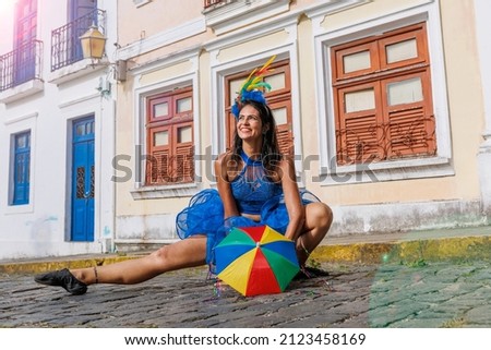 Beautiful Latin dancer dressed up for Carnival on the streets of Olinda. Frevo Recife. Brazil colors. Historical city.