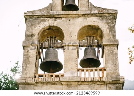 Three bells on the bell tower of the Church of the Nativity of the Virgin in Prcanj Royalty-Free Stock Photo #2123469599