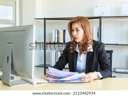 Shot of beautiful asian businesswoman company employee sitting at office desk looking at computer screen feels confident. Successful independent concept