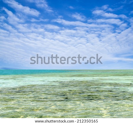 turquoise sea against the sky with clouds