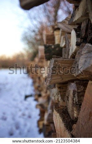 Stacks of wood in the snow ready for the winter season.