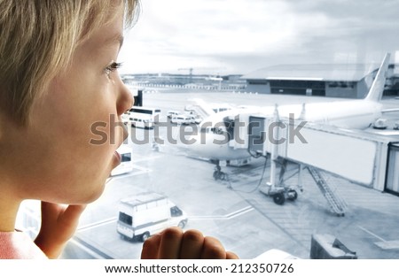 Cute boy looking at planes in the airport with great interest Royalty-Free Stock Photo #212350726