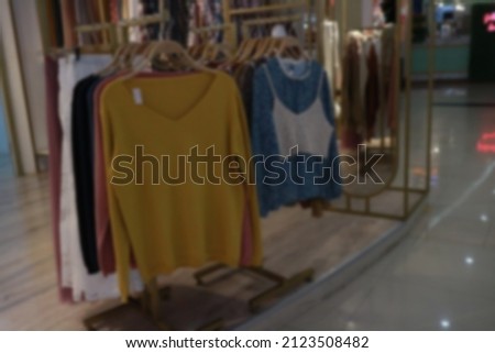 defocused colorful girl clothes with feminine style hanged at the mall
