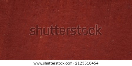 photo of red textured cement wall 