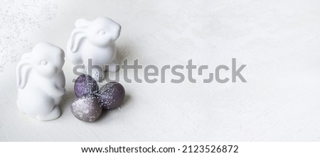 rabbits, painted eggs. Easter symbols on a light background. copy space. Banner
