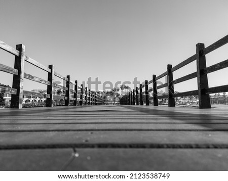 Black and white view of a wooden bridge in La Paz Mexico. Cuauhtemoc Pier.