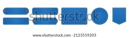 Denim cloth patches, labels with blue jean fabric texture. Vector illustration of fashion tags from blue canvas material with yellow stitches and rivets isolated on white background Royalty-Free Stock Photo #2123559203
