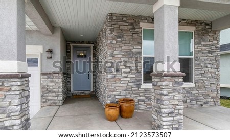 Panorama House exterior with stone veneer siding and garage Royalty-Free Stock Photo #2123573507