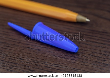 Pen caps have a small hole to prevent choking if swallowed and to equalize the pressure inside the pen to keep it from leaking. Royalty-Free Stock Photo #2123615138