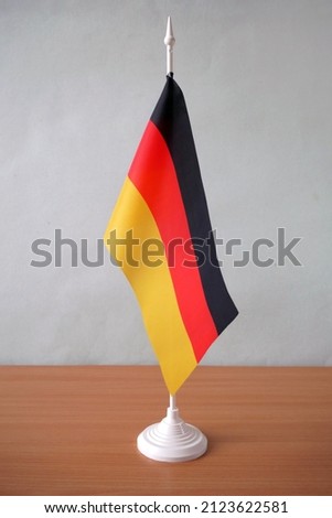 Majestic Glossy German Flag, official colors of National Germany flag stands on table