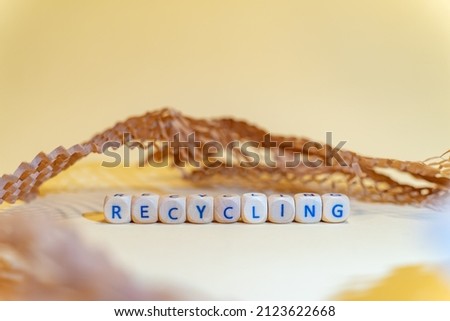 RECYCLING - words from wooden blocks with letters, from information term, packaging material background