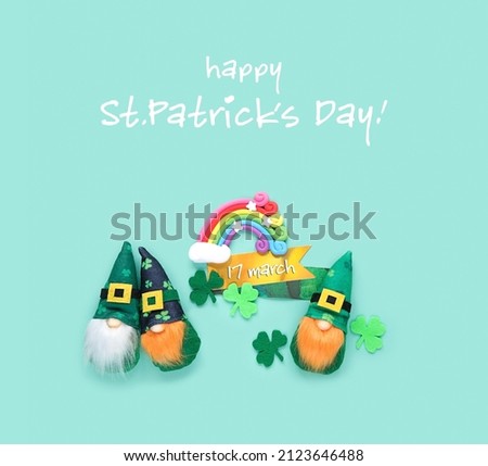 Cute irish gnomes, decorative clover leaves and toy rainbow on abstract green background. happy St.Patrick`s day greeting card. 17 march holiday concept. close up. flat lay