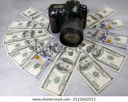 digital camera and money, store selling photographic equipment, pawnshop concept, closeup