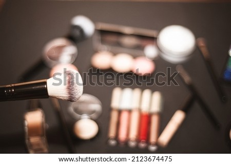 Makeup brushes on a black background, with a place to insert text, beauty