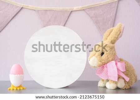 Wood white round sign easter mockup with stuffed toy bunny and easter eggs on white background, cottagecore aesthetic