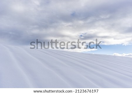 abstract picture of a hill full of snow with cloudy sky 