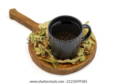 Herbal tea on a white background. Linden tea. immune-boosting herbal tea. Medicinal tea prepared from linden leaves, Clove particles and Chamomile.
