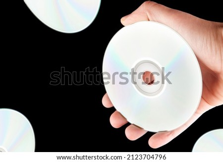 image of cd disk hand dark background  Royalty-Free Stock Photo #2123704796
