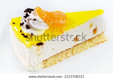 Piece of yogurt citrus cake with cream and cherry on white background