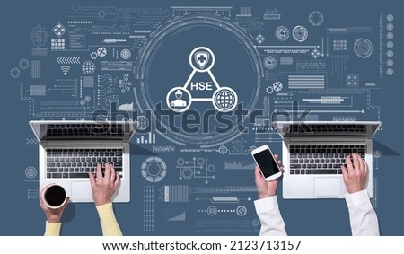 Top view of hands using laptop with symbol of hse concept