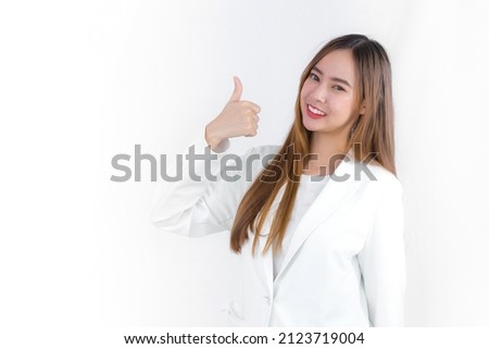 Portrait beautiful business professional Asian woman in white formal suit shows hand thump up as good job sign on white background.