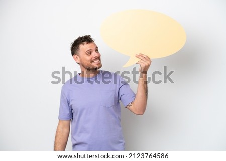 Young Brazilian man isolated on white background holding an empty speech bubble
