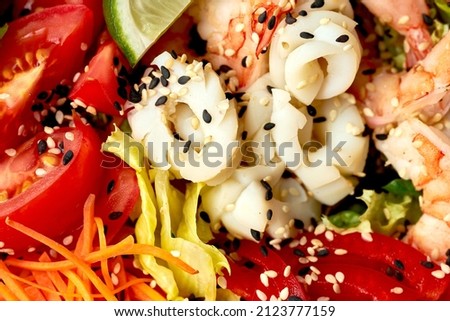 Close-up on a salad with shrimp, squid. Macro photography, selective focus