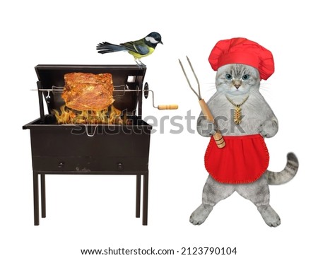 An ashen cat in a red chef hat and an apron with a barbecue fork grills meat on a skewer. White background. Isolated.