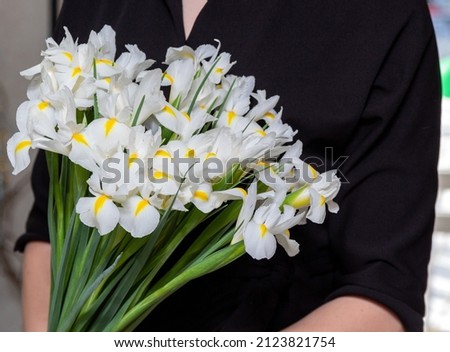 Bouquet of white irises. Gift for women's Day. An image for a flower shop, a postcard. Selective focus.