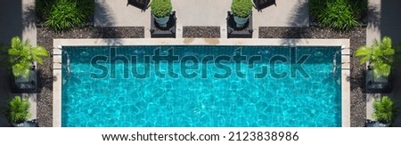 Swimming pool blue water in summer top view angle. Aerial view images of swimming pool in a sunny day which suitable for sport or relax on vacation time or workout for burn some calories in holiday. Royalty-Free Stock Photo #2123838986