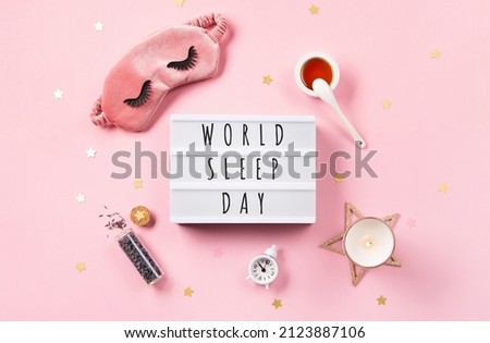 World Sleep day observed on March 18th. Quality of sleep, good night, insomnia, relaxation concept. Sleeping mask, golden stars, candle, lavender and alarm clock on pink background. Flat lay, top view