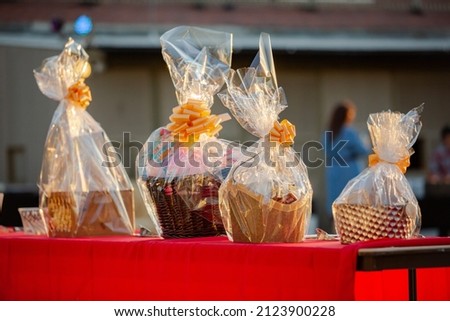 Auction prize gift baskets on red table Royalty-Free Stock Photo #2123900228